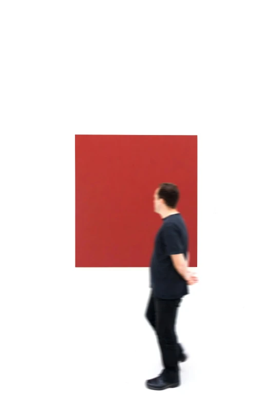 a man standing in front of a large painting