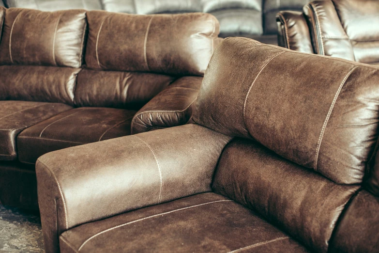 a living room scene with two recliners, two cushions and one arm chair