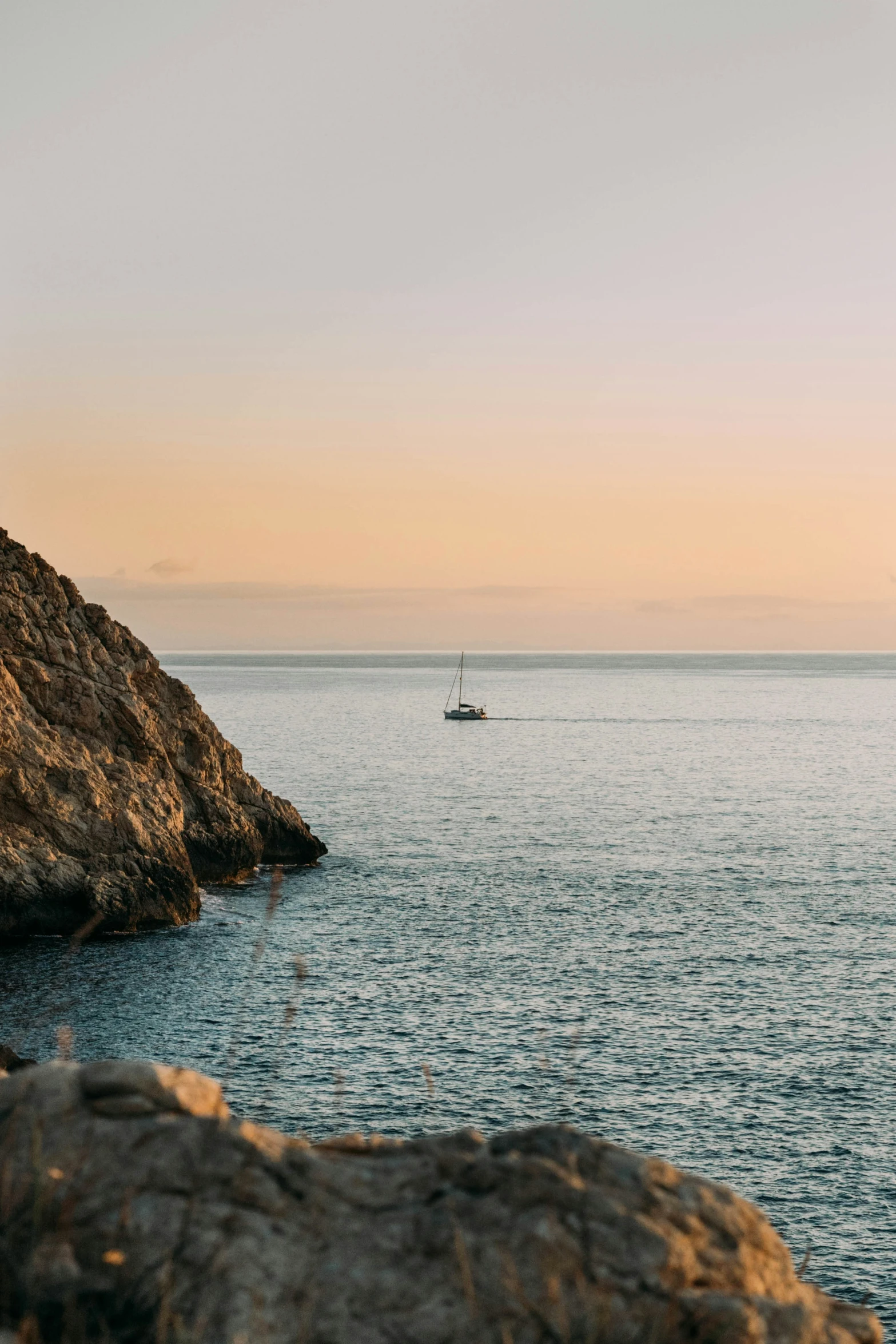 a boat in a lake by some rocks