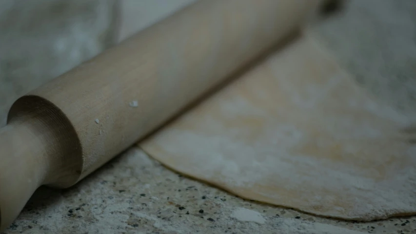 a rolled up roll of dough sitting on top of a table