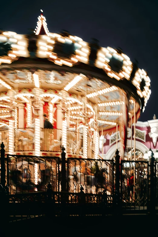 a large merry go round at night with the light on
