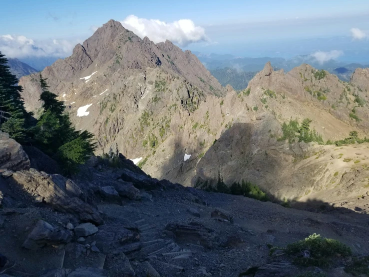 some tall mountains in the distance with trees on them