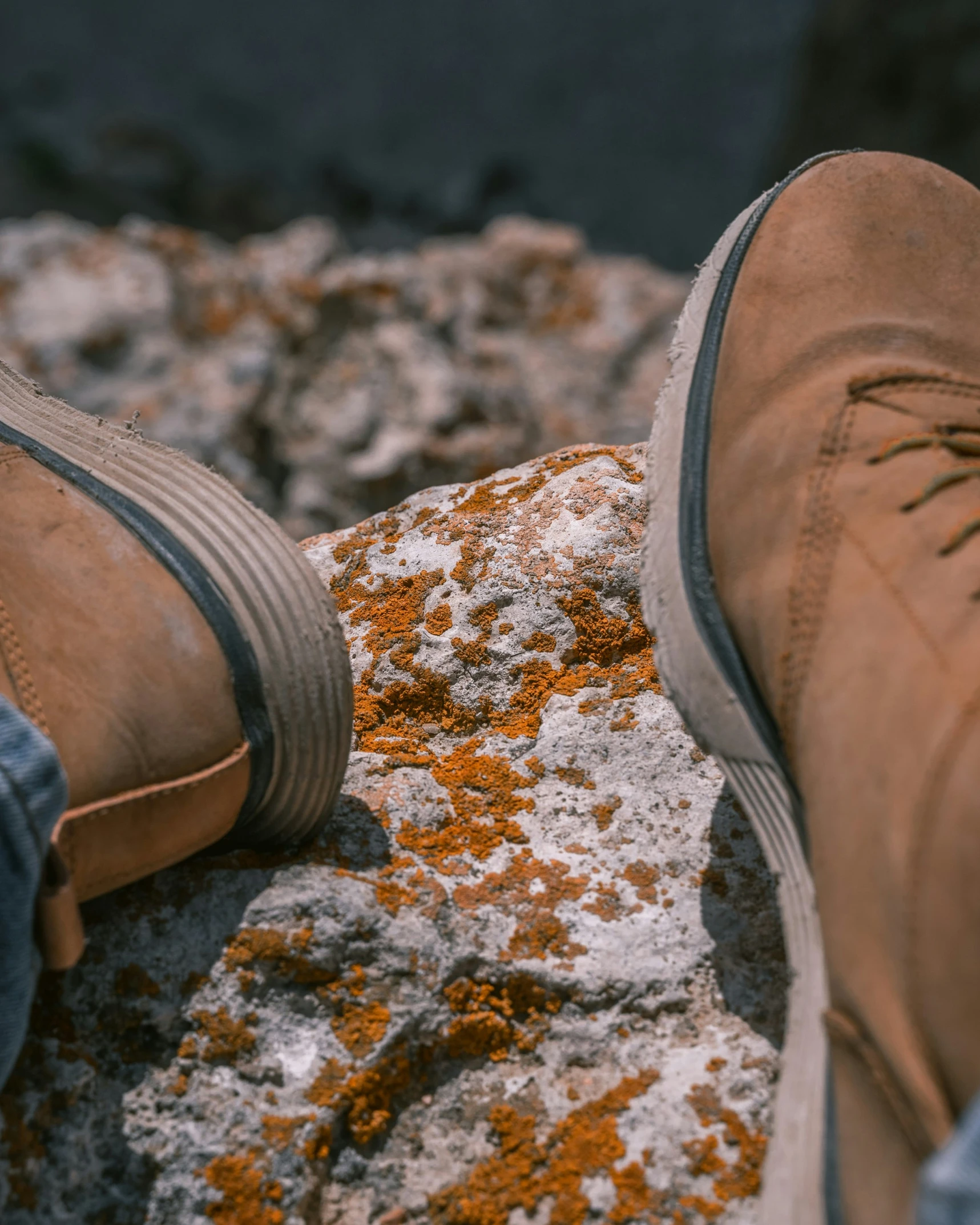 a person wearing shoes on top of a rock