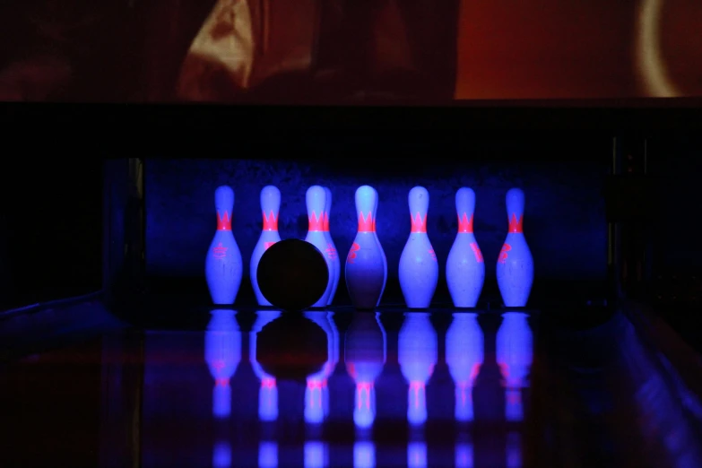 bowling pins lined up against a purple background