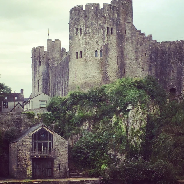 castle on a hill with water below