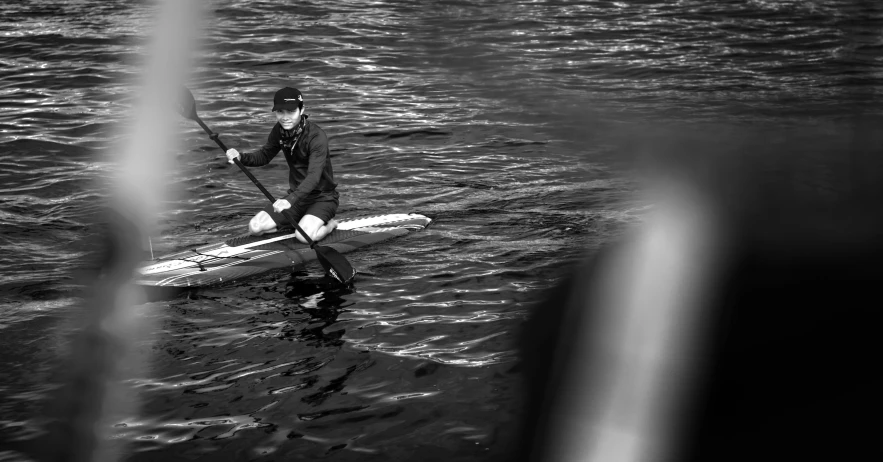 a man is on his knees on top of a canoe