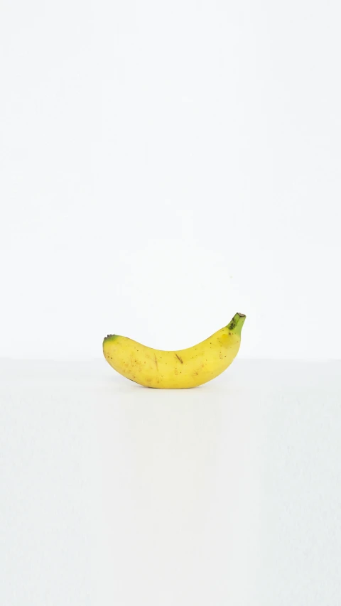 a close up of a ripe banana on a white surface