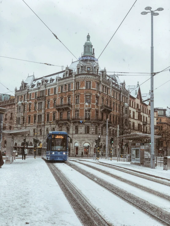 a passenger train in a snowy street is seen here