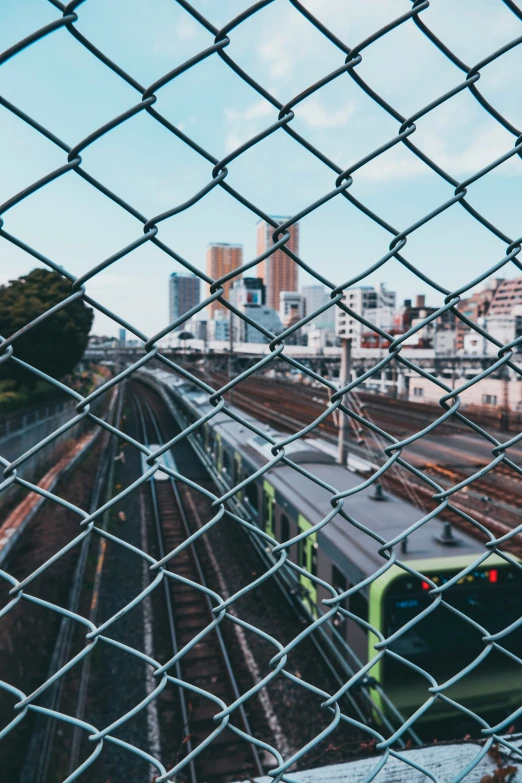 a view of a train from behind a chain link fence