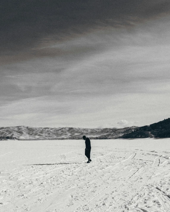 a lone person on snow with a mountain in the background