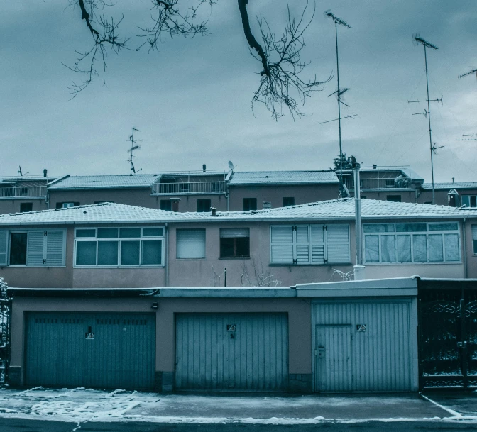 an old brick building with many garages is seen in the background