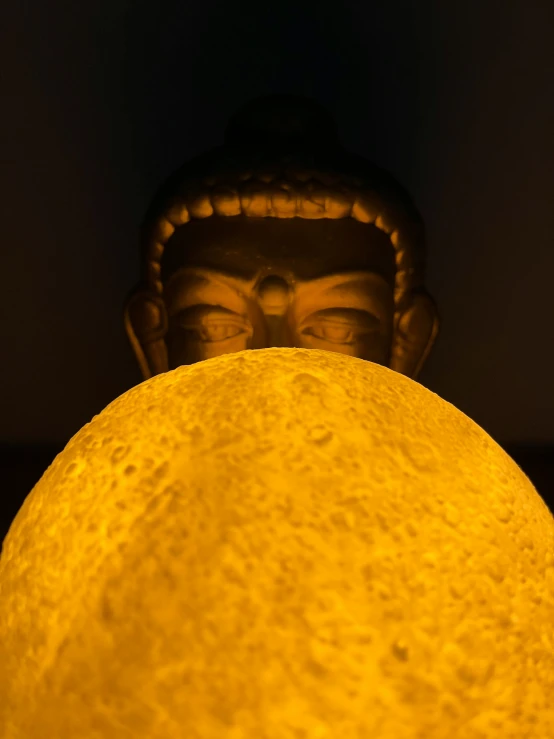 a close up po of the face of a statue of buddha