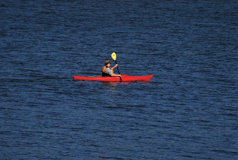 a person on a kayak paddling in the water