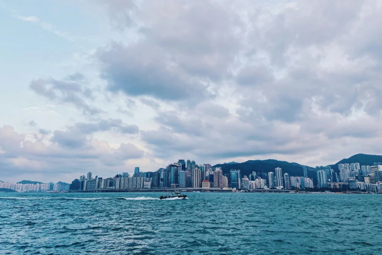 some buildings and a boat in the water and some clouds