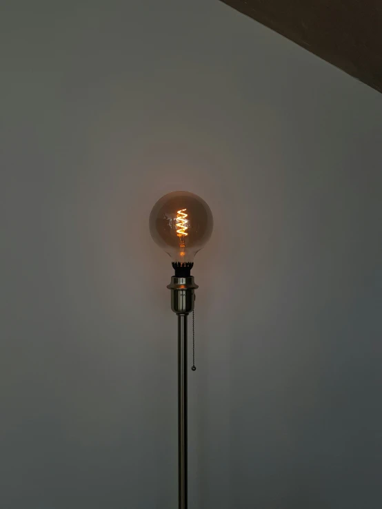 a lighted lamp that is on a pole