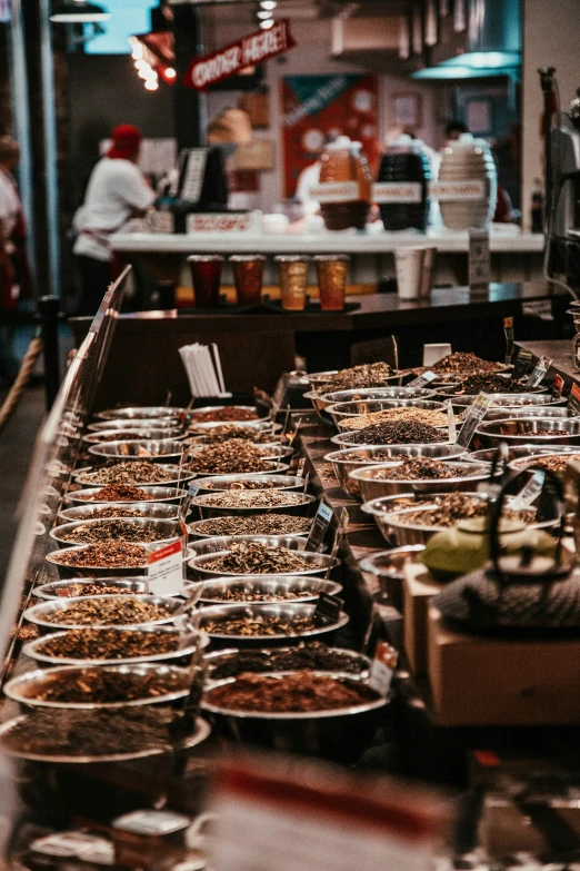 the buffet has several plates with food and people