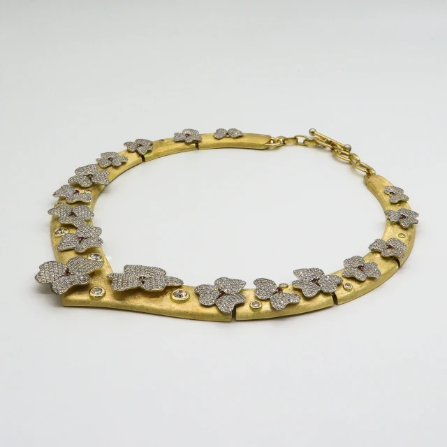 an ornate gold necklace with stones on it