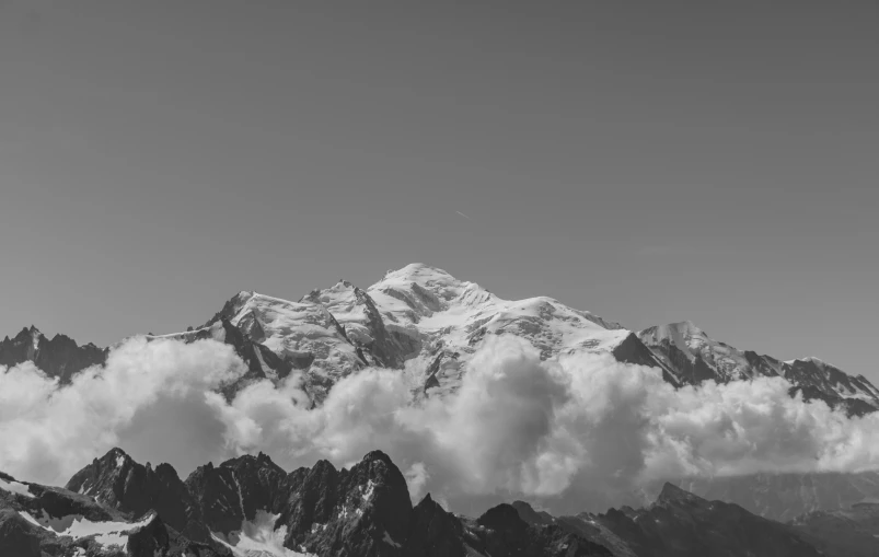 a high mountain peak in the middle of some clouds