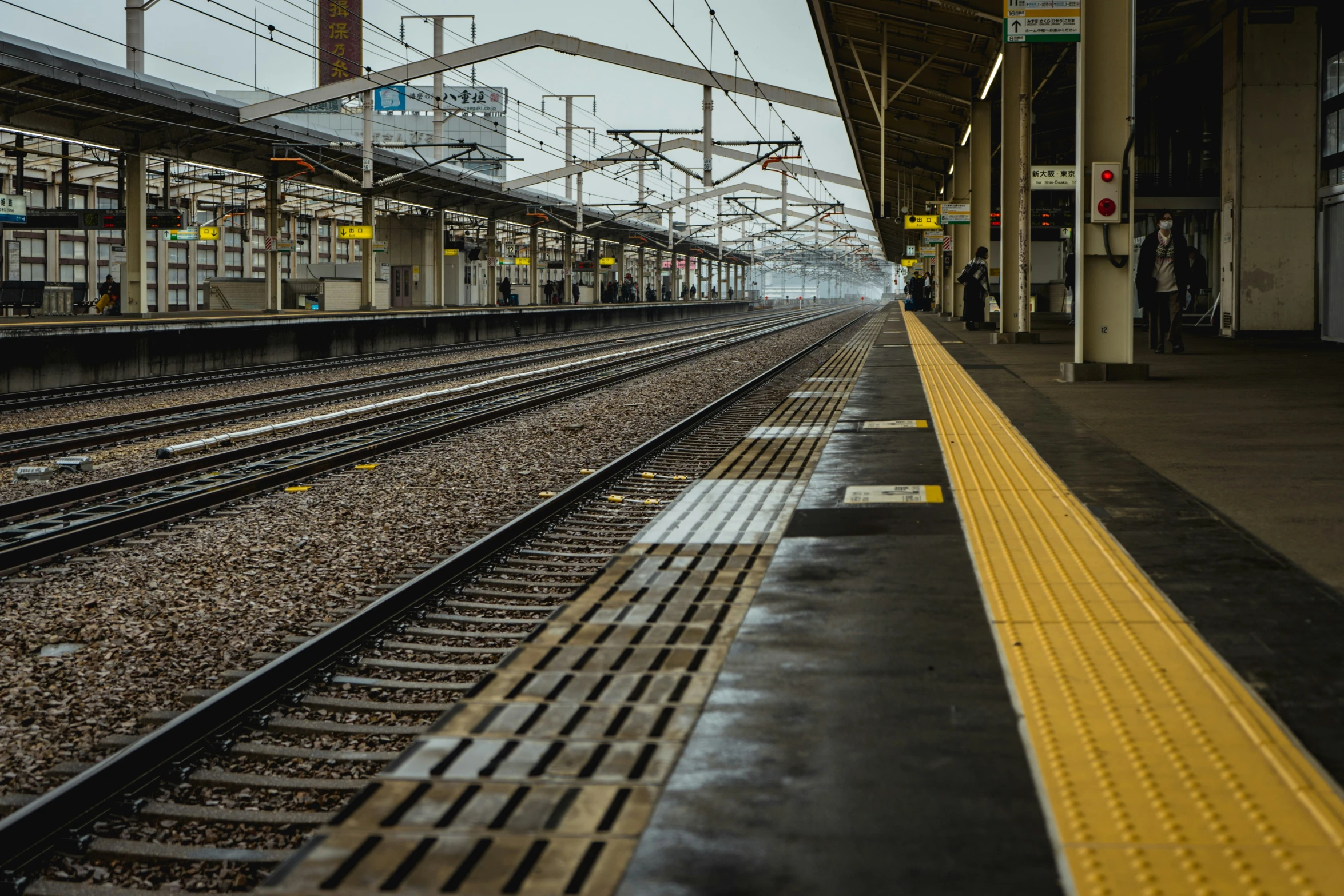 an empty train station with train tracks near the ground