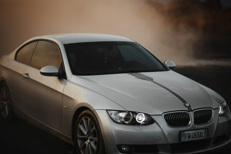 a silver car is next to a smoke bomb