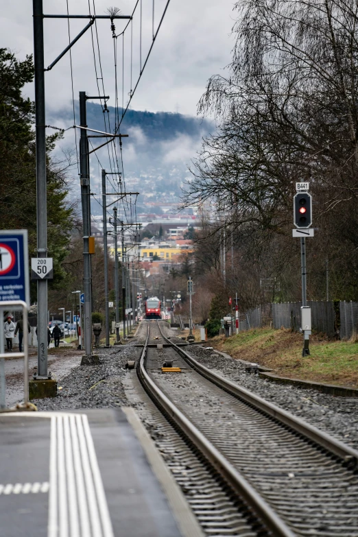a train track and some traffic lights at an outdoor station