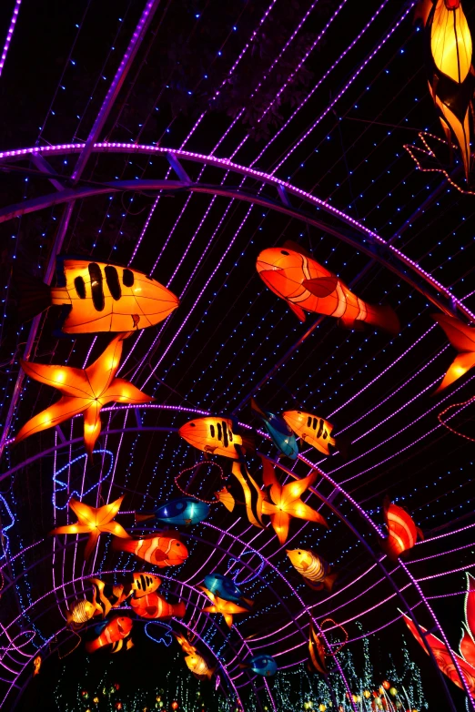 colorful lights are in the air above a carnival