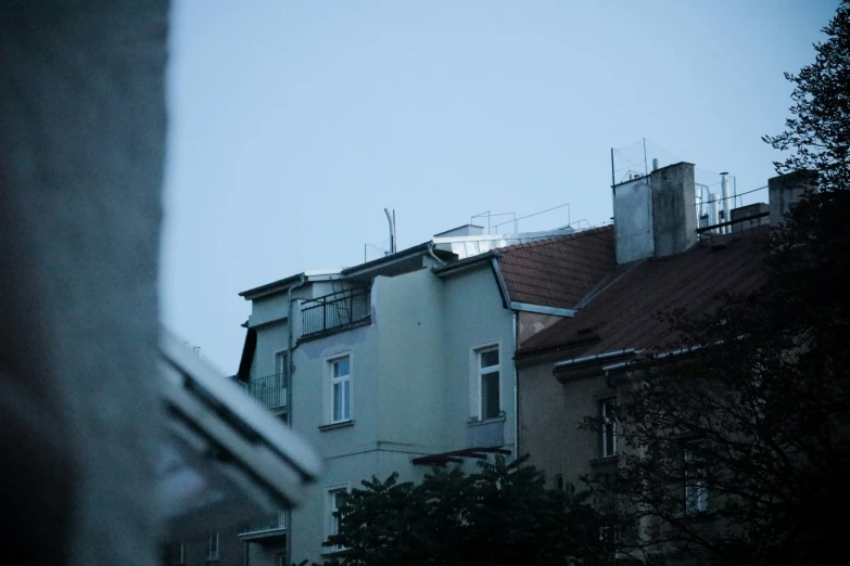 a row of houses with a small bird perched atop top of one