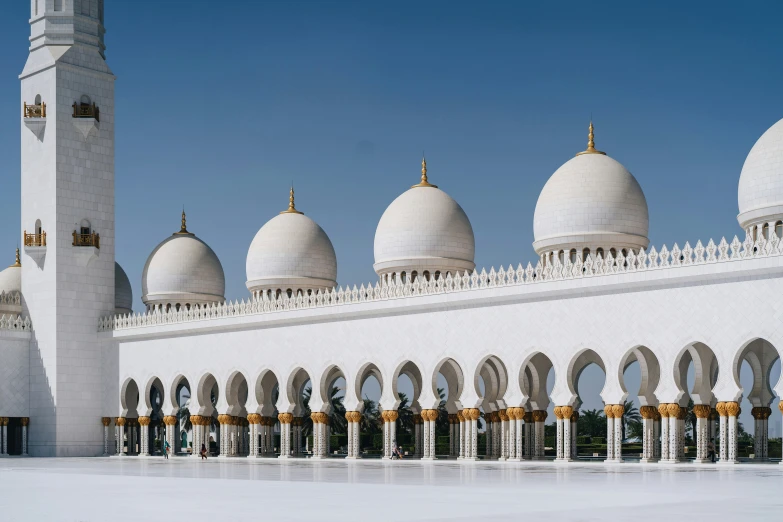 a tall white building with multiple pillars around it