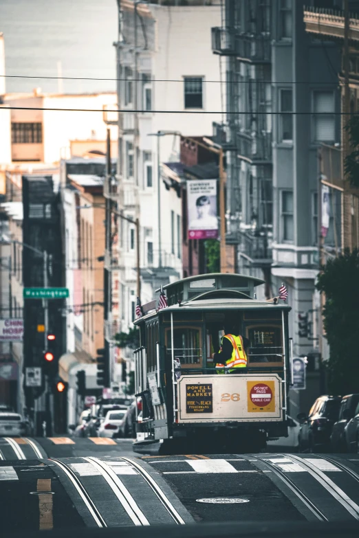 an electric trolly drives down the busy city street