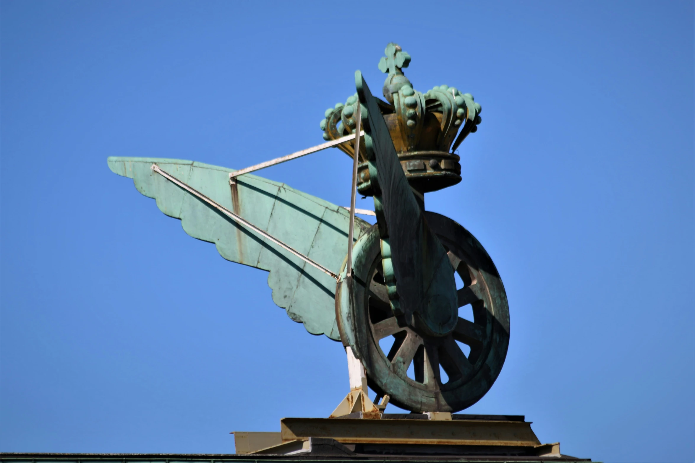 a large metal sculpture with a sky background