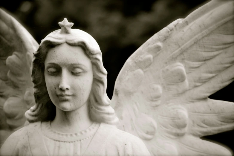 a statue of a woman with wings and a crown