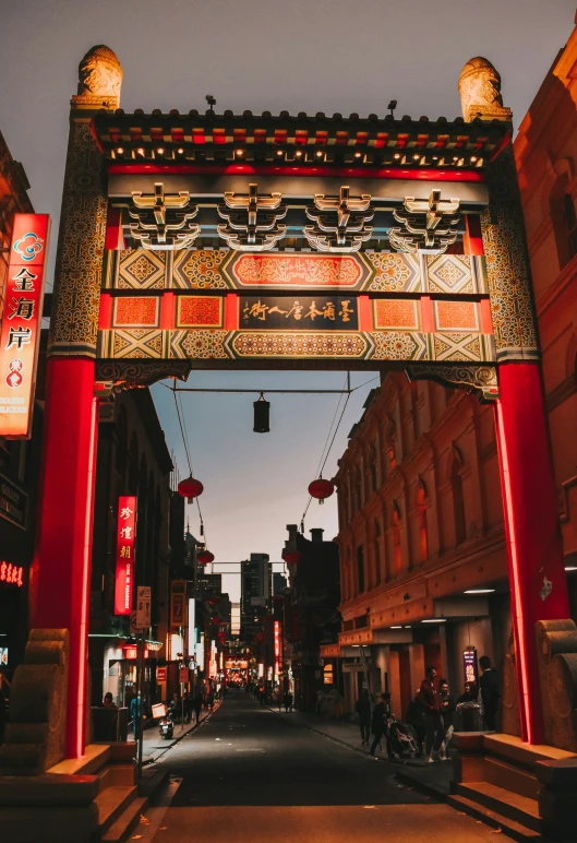 an open chinese - style gate stands in the middle of the city