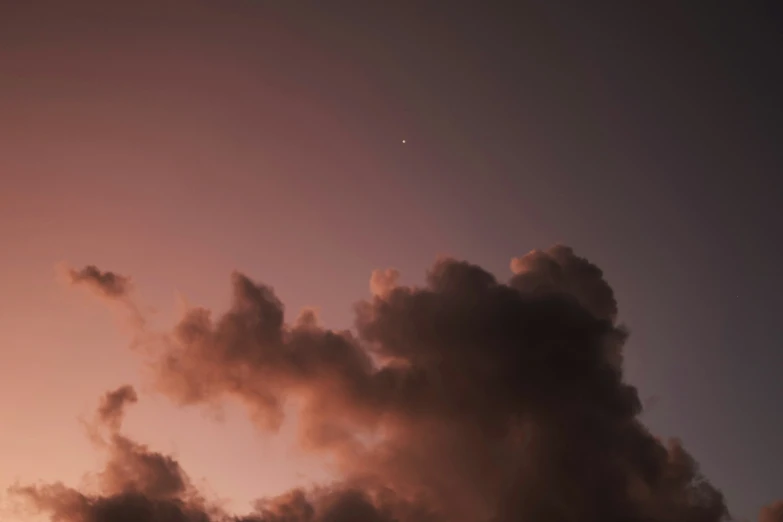 a plane flying in the sky with a contrail