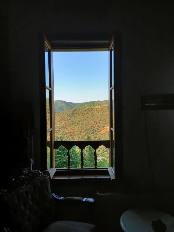 a room with a window open to a beautiful view