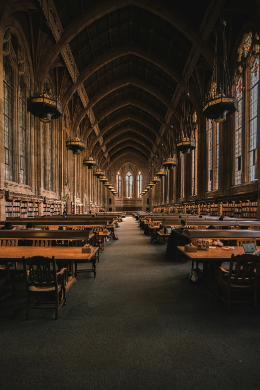 long tables with books on them sitting in a room