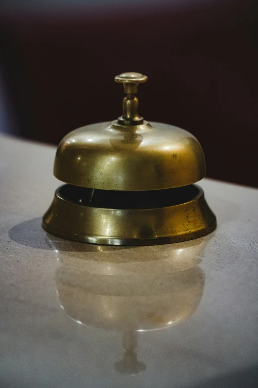 a white counter top with a ss bell on top