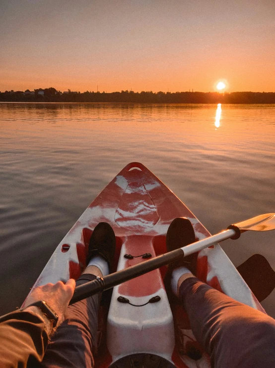 a man on a boat is paddleboarding in the water