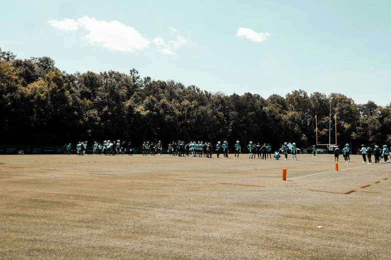 several people on a field playing softball together