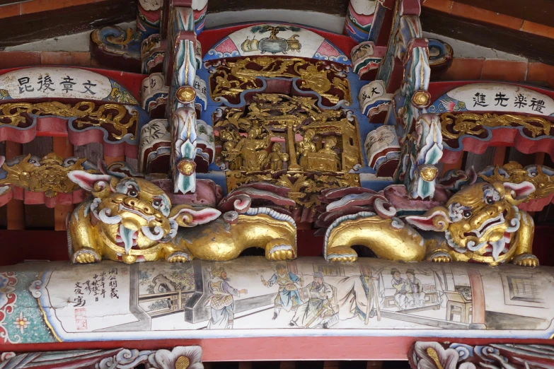 a golden lion statue sits on the side of a building