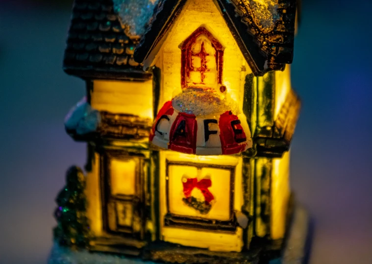 a miniature house shaped like a light with christmas lights around it