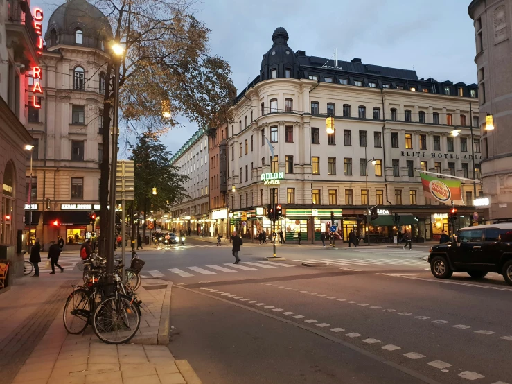 several buildings and a city street at dusk