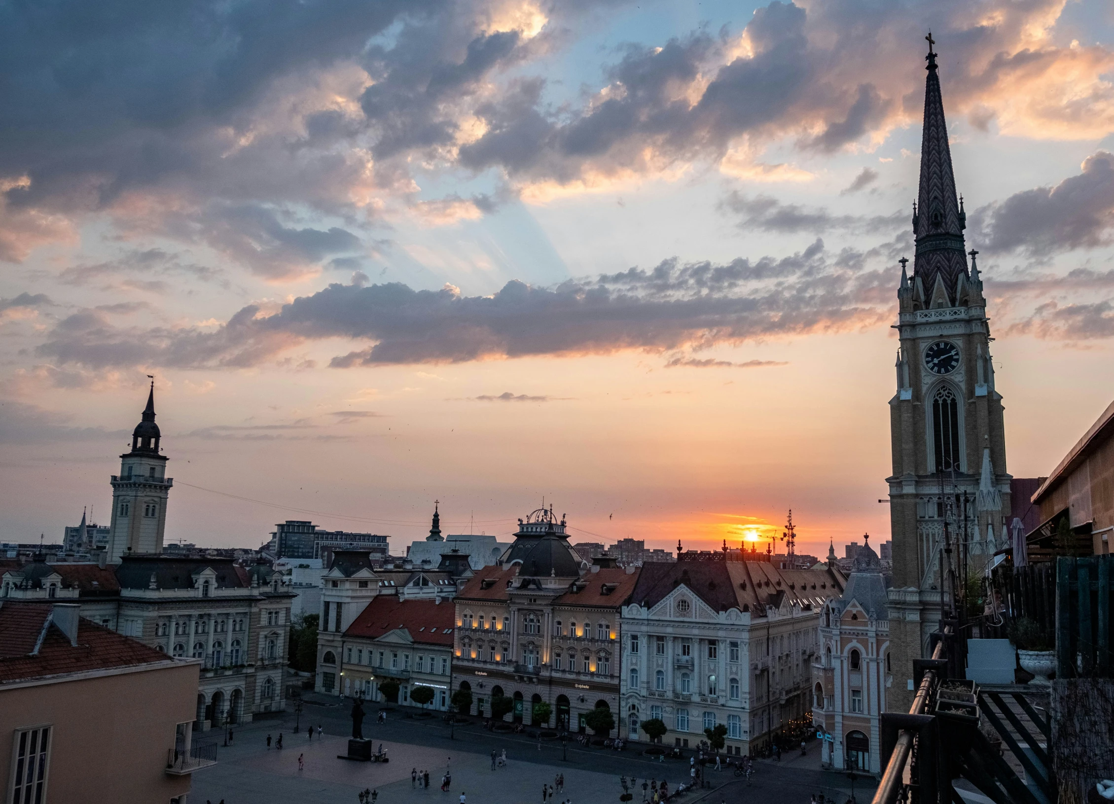 sunset behind large buildings in a european city