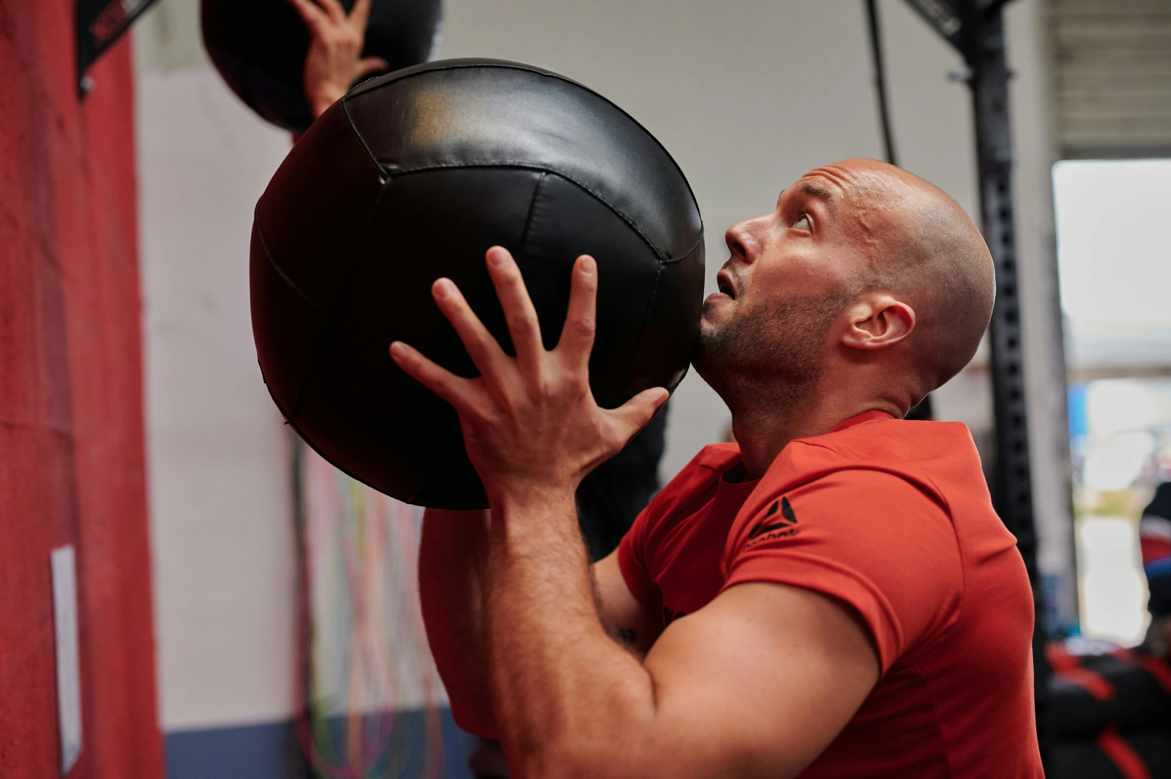 a man with a medicine ball lifting the weight