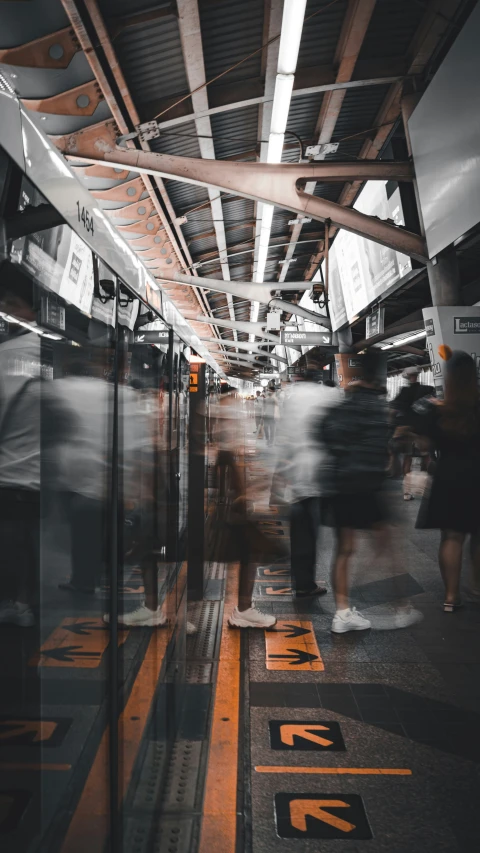 people walking in an empty bus station