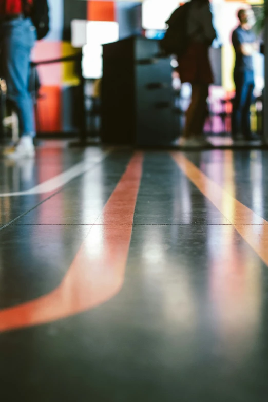 a group of people standing next to an airport baggage claim