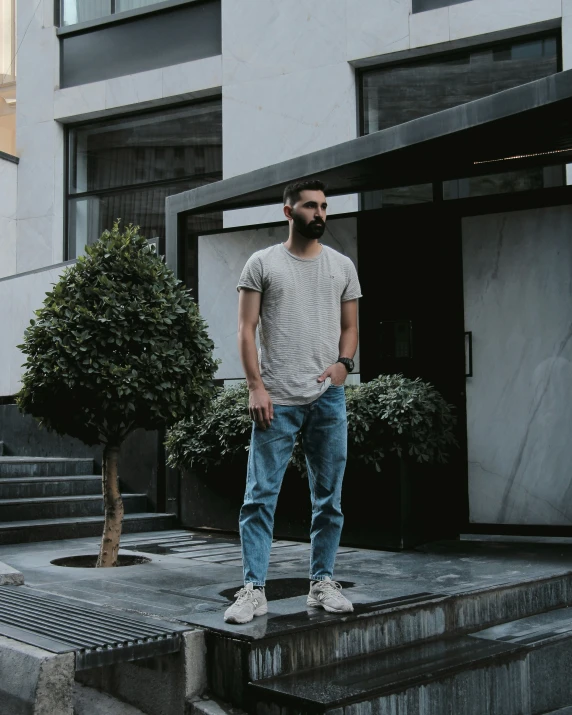 a man with a beard standing on steps