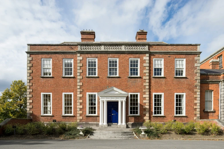 this is a large red brick building with white trim and doors