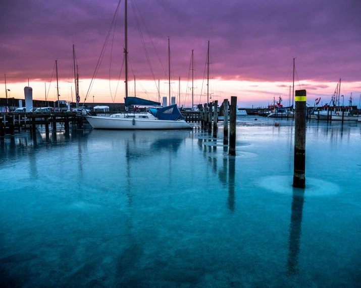 boats docked in the dock at dusk