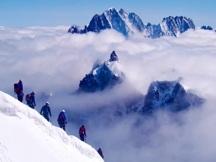 a mountain scene with people standing on top