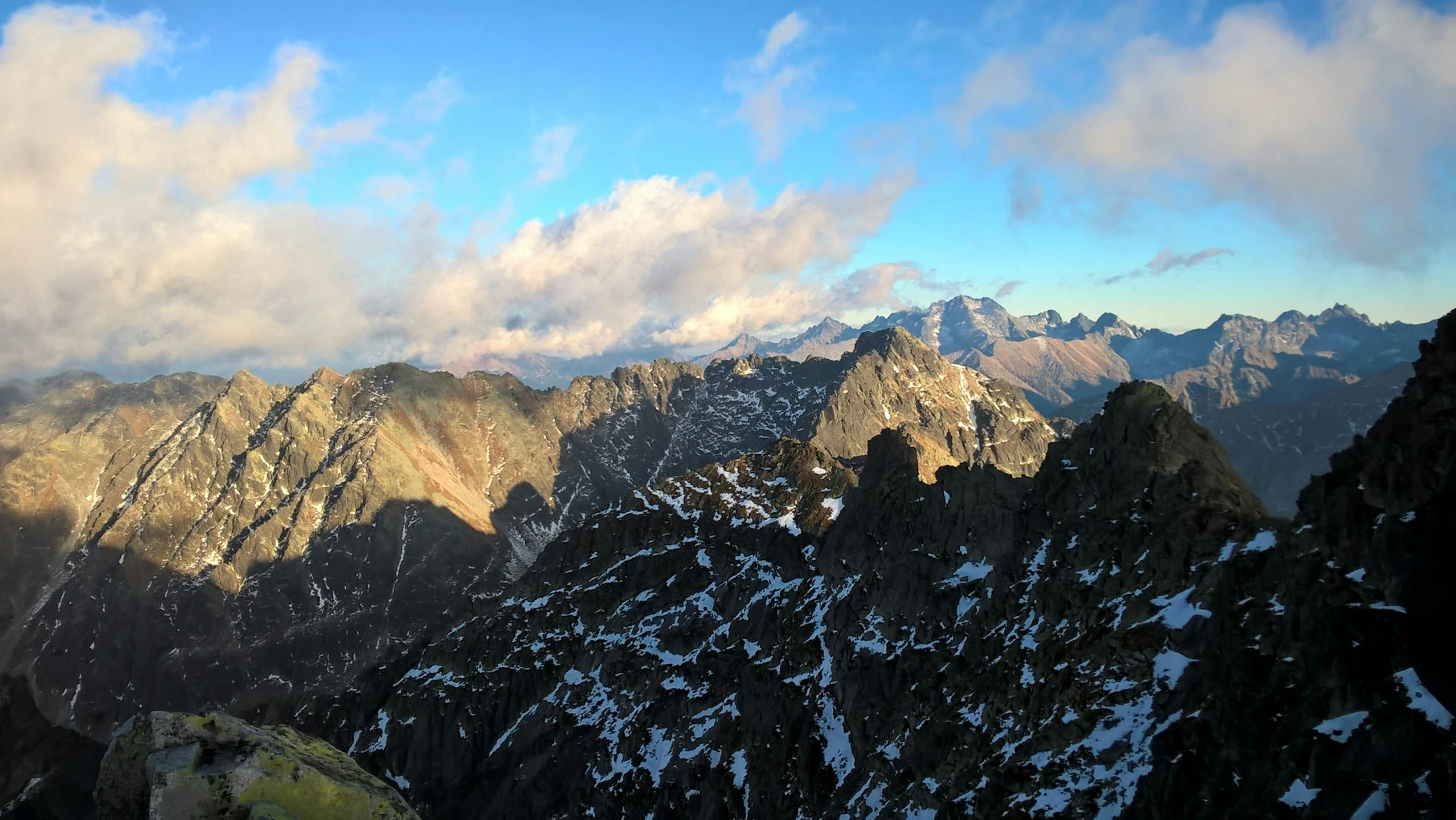 mountains are covered in snow in the evening